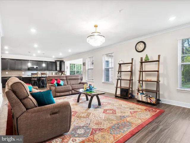 a dining room with furniture a window and wooden floor