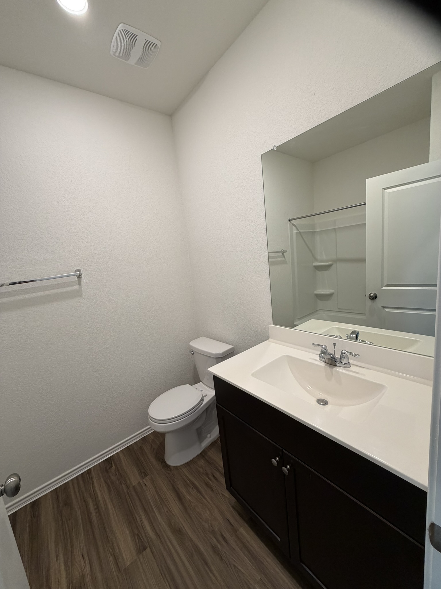 408 Buckners Street Georgetown, TX 78626 - Photo 4 of 15 a bathroom with a sink a toilet a mirror and vanity