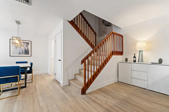 a view of hallway with wooden floor and stairs