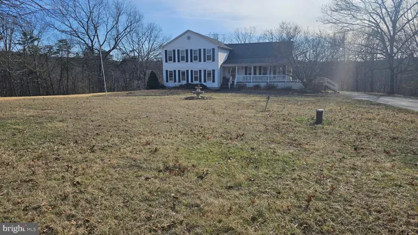 a view of a house with a yard and fence