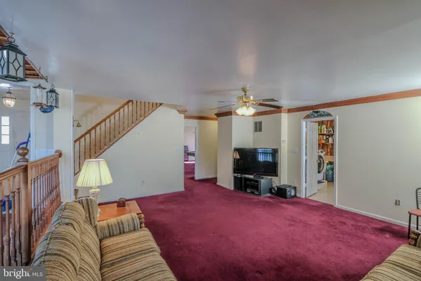 a bedroom with a bed a dresser and flat screen tv