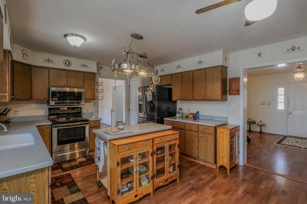 a view of a room with wooden floor and ceiling fan