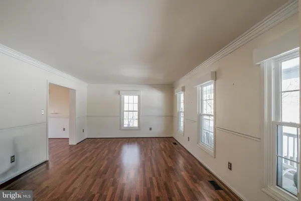 an empty room with wooden floor and closet