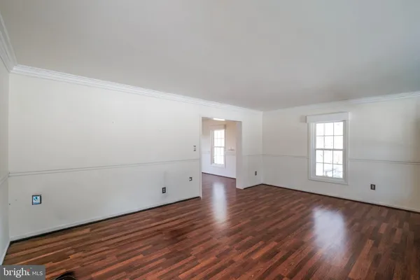 a view of a room with wooden floor and white walls