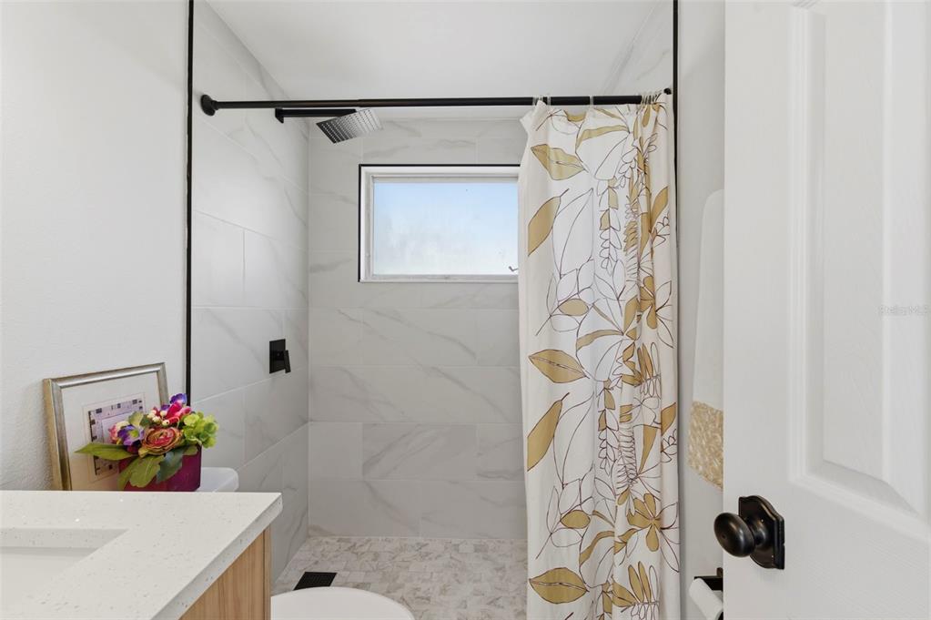 9033 Pegasus Avenue Port Richey, FL 34668 - Photo 33 of 56 a bathroom with a sink toilet and shower