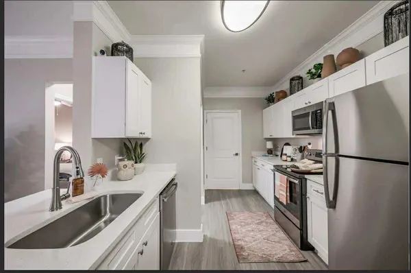 a kitchen with a refrigerator sink and stainless steel appliances