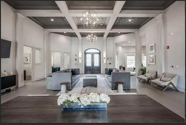 a living room with furniture fireplace and wooden floor