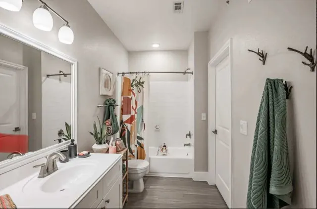 a bathroom with a sink toilet and shower