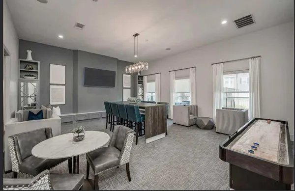 a view of a dining room with furniture and window