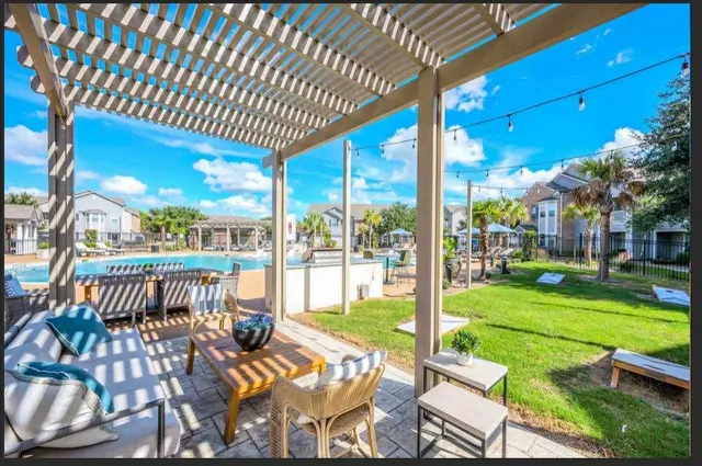 a view of a patio with a table chairs couches and deck