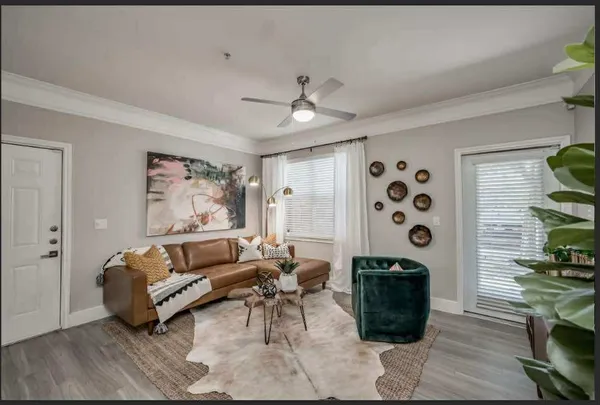 a living room with furniture a rug and a window