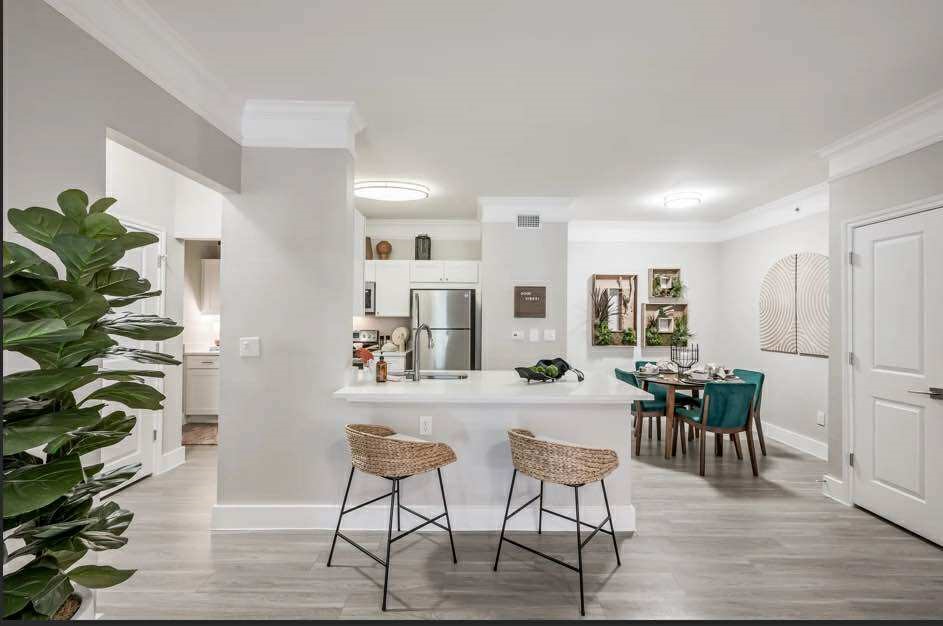 529 Barker-Clodine Road, Unit CYPRESS Houston, TX 77094 - Photo 10 of 21 a view of a dining room with furniture and wooden floor
