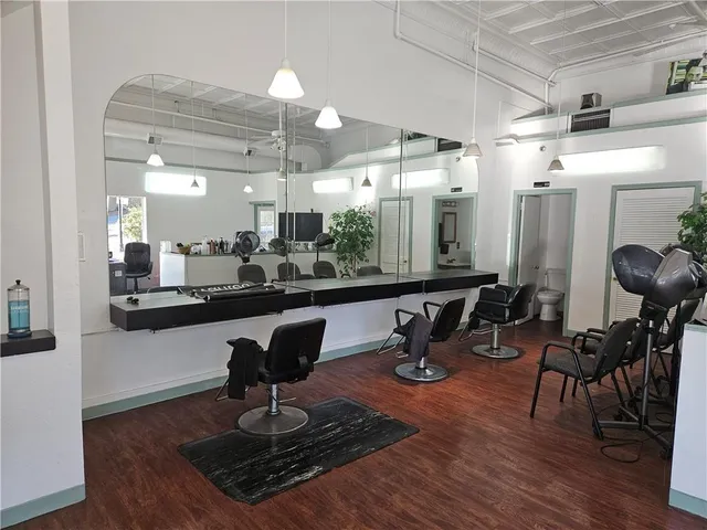 a room with lots of chairs and wooden floor