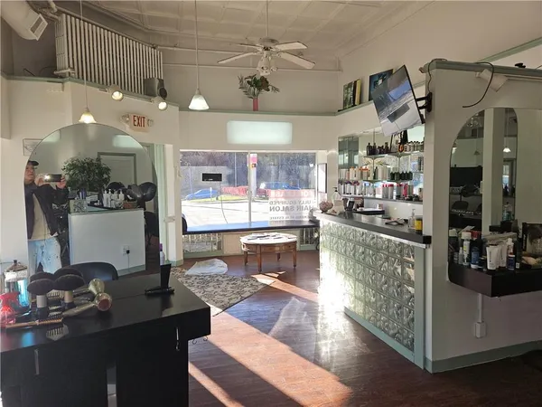 a living room with lots of furniture and kitchen view