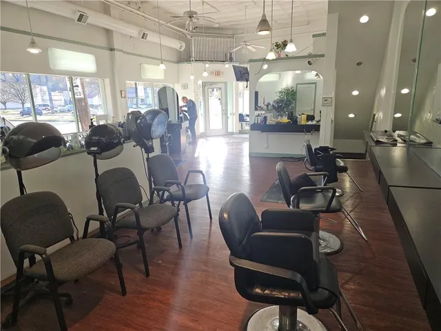 a view of a dining room with furniture a chandelier and wooden floor