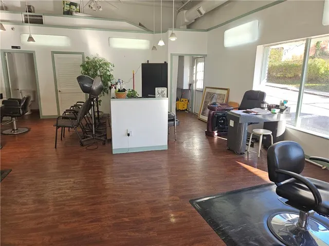 a view of a dining room with furniture and a chandelier