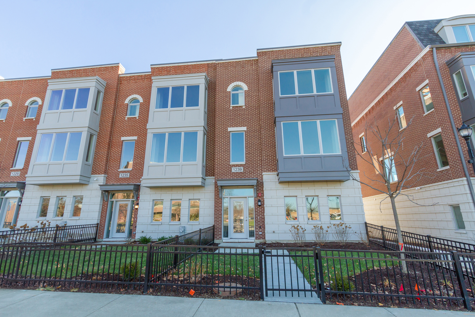 1239 Shermer Road Northbrook, IL 60062 - Photo 1 of 25 a front view of a residential apartment building with a yard