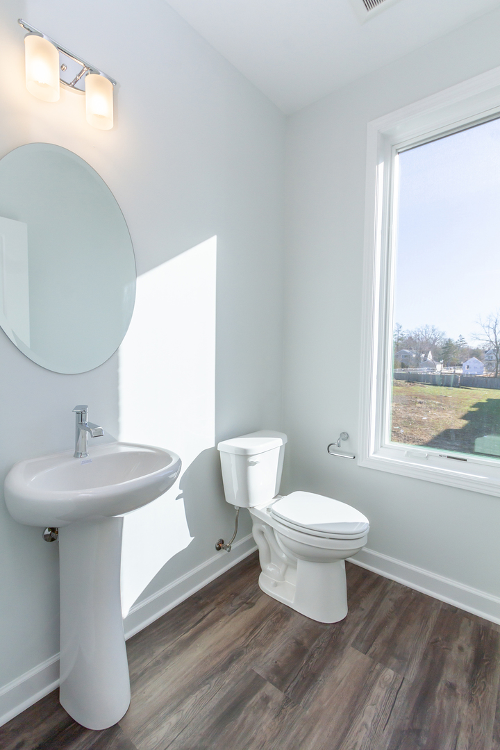 1239 Shermer Road Northbrook, IL 60062 - Photo 9 of 25 a white toilet sitting next to a bathroom sink