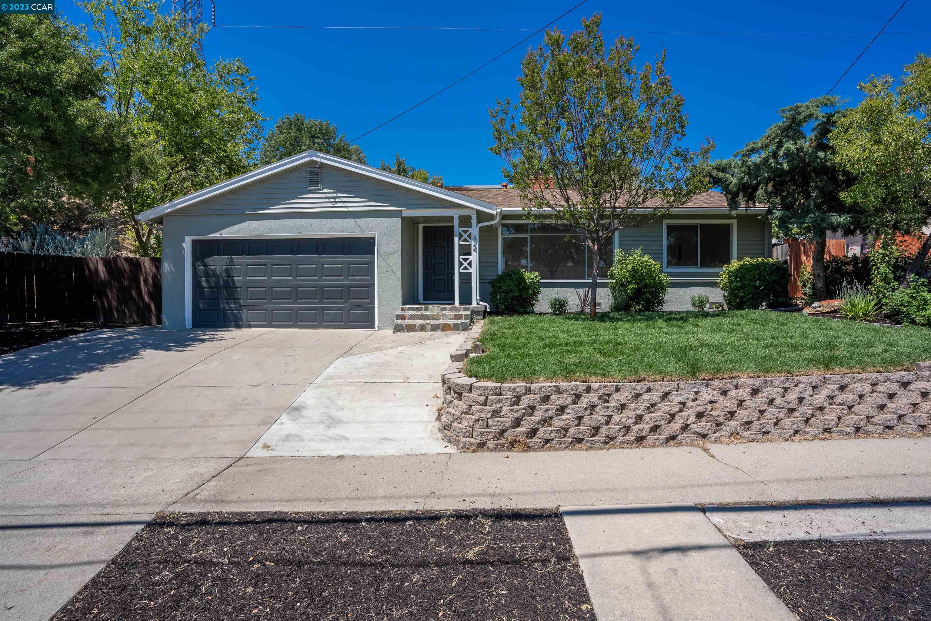 42 Clearbrook Road Antioch, CA 94509 - Photo 1 of 1 a front view of a house with a garden and a tree
