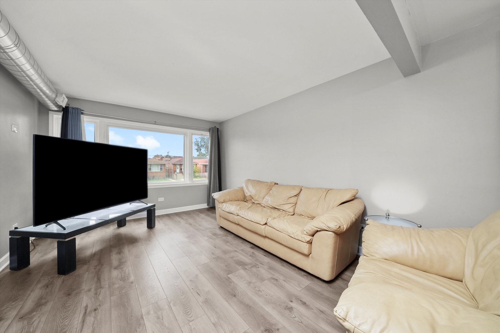 7524 West 63rd Place Summit, IL 60501 - Photo 2 of 44 a living room with furniture and a flat screen tv