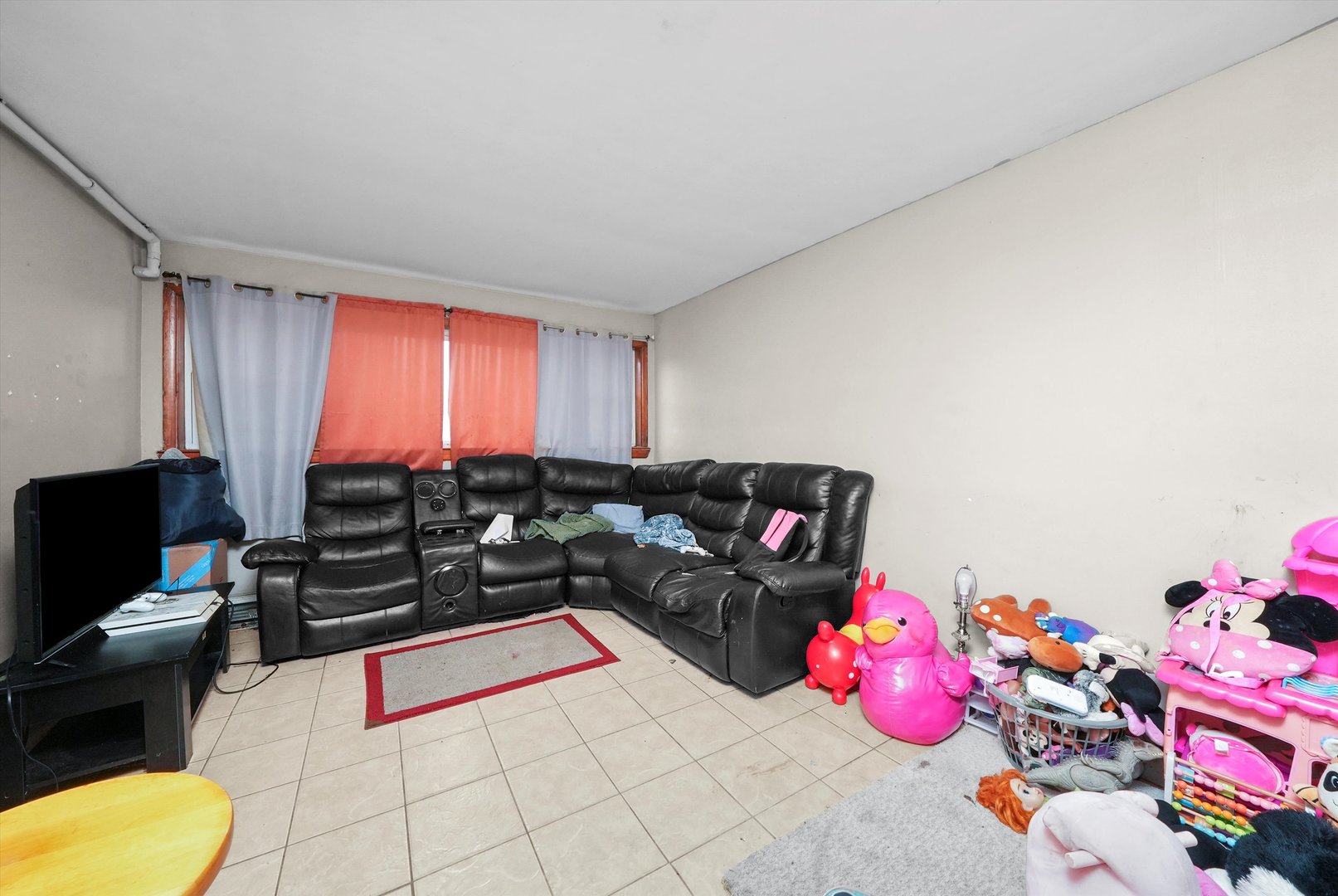 7524 West 63rd Place Summit, IL 60501 - Photo 24 of 44 a living room with a couch and a chandelier