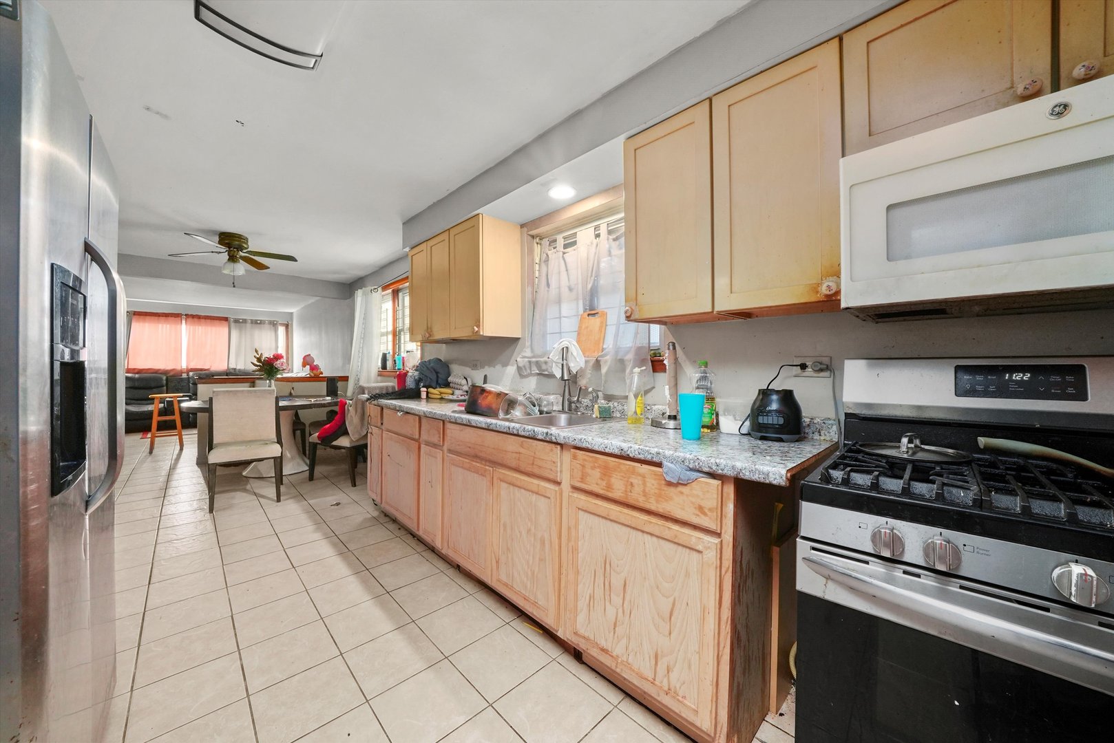 7524 West 63rd Place Summit, IL 60501 - Photo 30 of 44 a kitchen with stainless steel appliances granite countertop a stove top oven a sink dishwasher and cabinets with wooden floor