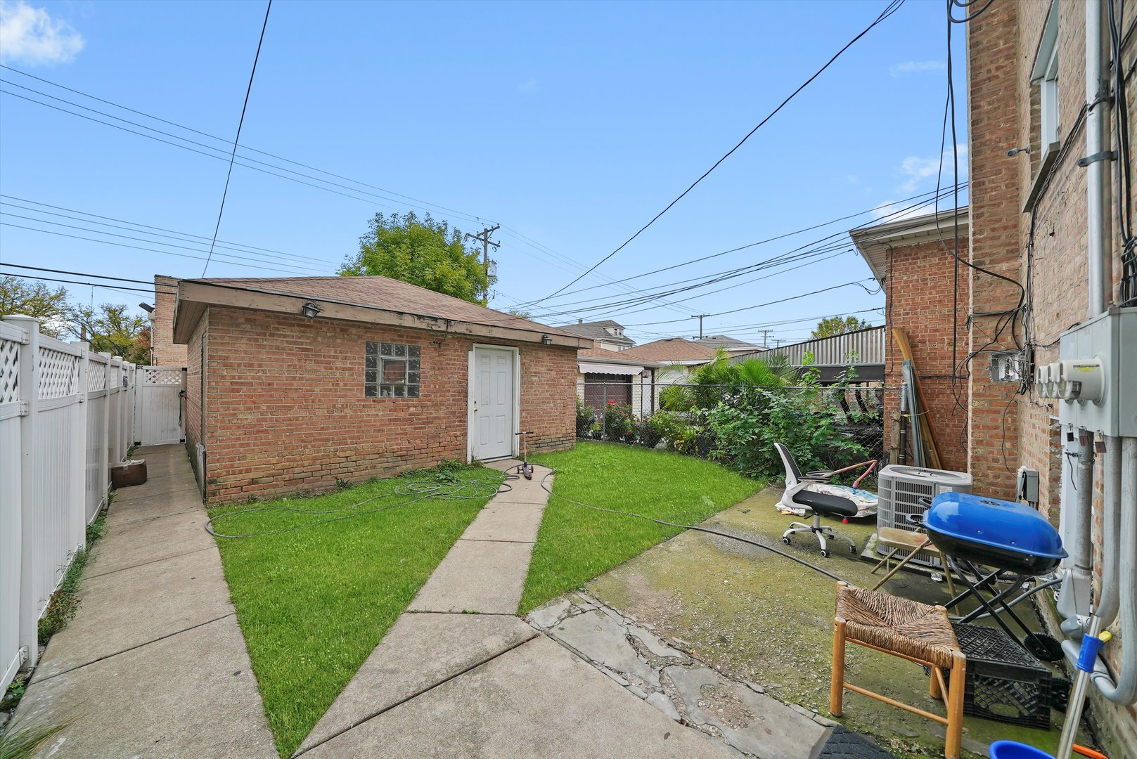 7524 West 63rd Place Summit, IL 60501 - Photo 33 of 44 a view of a backyard with table and chairs under an umbrella