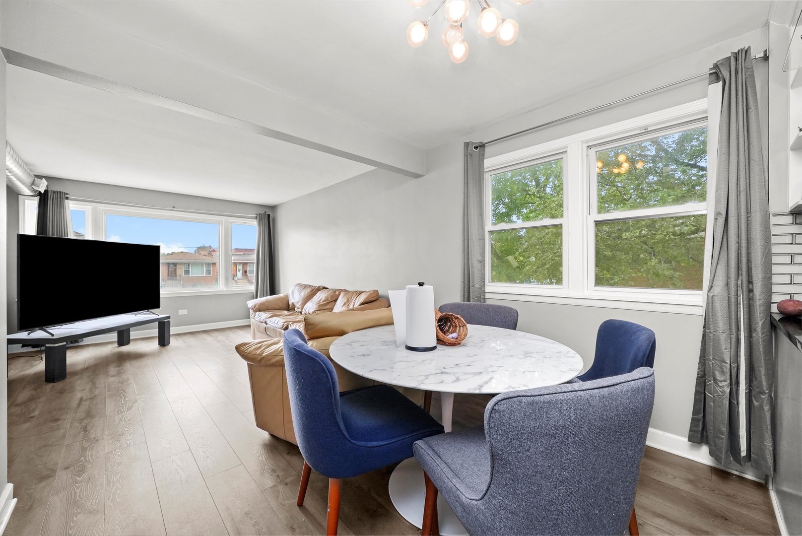 7524 West 63rd Place Summit, IL 60501 - Photo 4 of 44 a living room with furniture and a flat screen tv