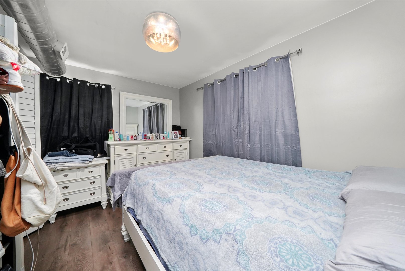 7524 West 63rd Place Summit, IL 60501 - Photo 6 of 44 a bedroom with a bed and a chandelier