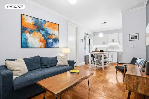 a living room with furniture and kitchen view