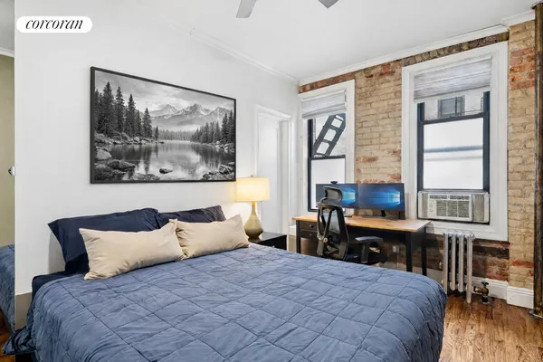 a bedroom with a bed and a large window