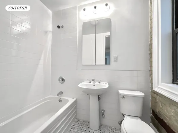 a bathroom with a sink a toilet and bathtub