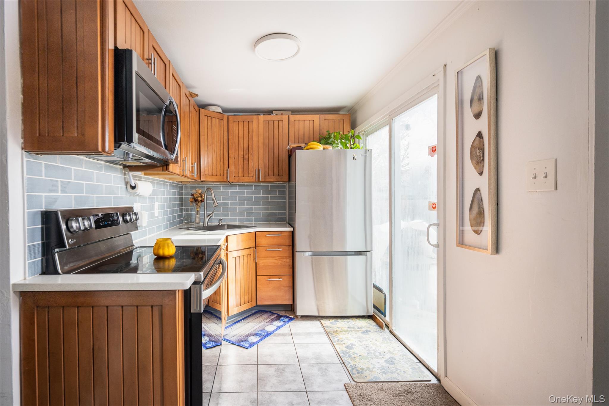 278 Elm Road West Mastic Beach, NY 11951 - Photo 6 of 14 a kitchen with stainless steel appliances a refrigerator a stove a sink and a cabinets