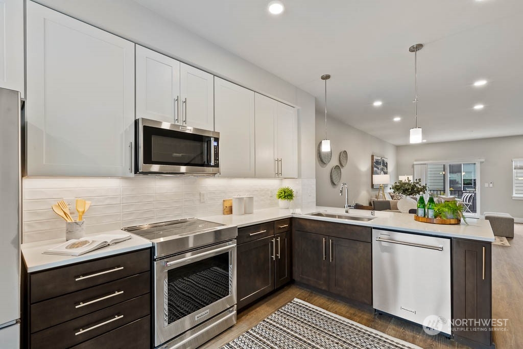 23833 9th Avenue Southeast, Unit B 19 Bothell, WA 98021 - Photo 11 of 32 a kitchen with stainless steel appliances a sink stove and microwave
