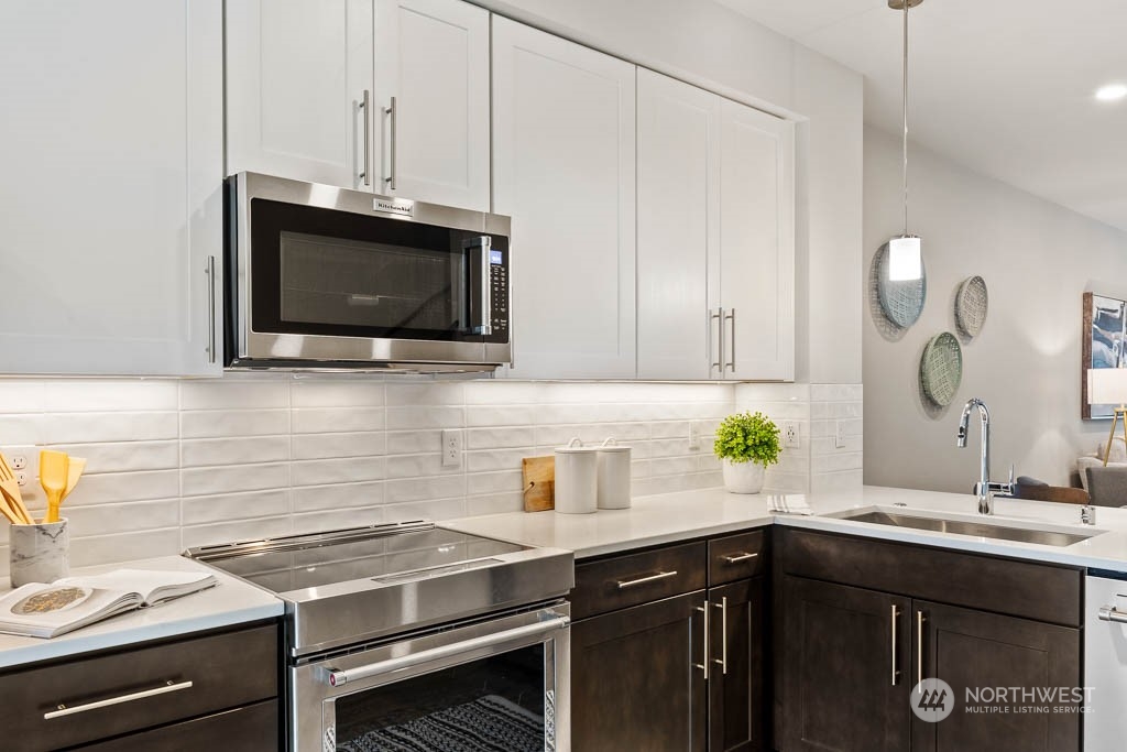 23833 9th Avenue Southeast, Unit B 19 Bothell, WA 98021 - Photo 12 of 32 a kitchen with a sink stove and microwave
