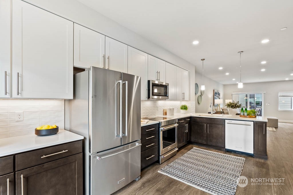 23833 9th Avenue Southeast, Unit B 19 Bothell, WA 98021 - Photo 13 of 32 a kitchen with stainless steel appliances a refrigerator sink and microwave