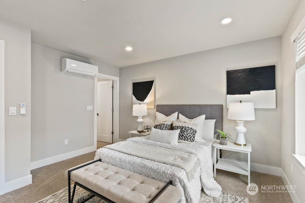 23833 9th Avenue Southeast, Unit B 19 Bothell, WA 98021 - Photo 22 of 32 a bedroom with a bed and a flat screen tv