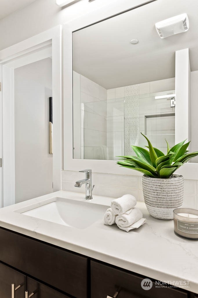 23833 9th Avenue Southeast, Unit B 19 Bothell, WA 98021 - Photo 25 of 32 a bathroom with a sink a mirror and a potted plant