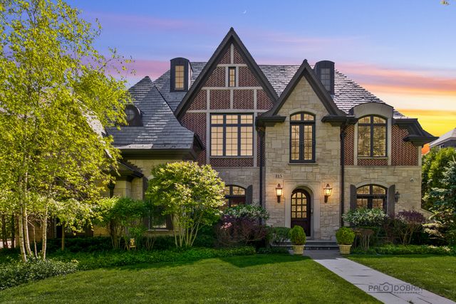 a front view of a house with a garden and plants