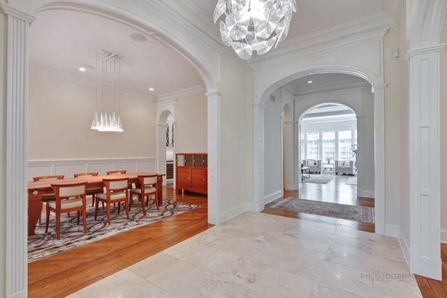 an entryway with a dining table and chairs