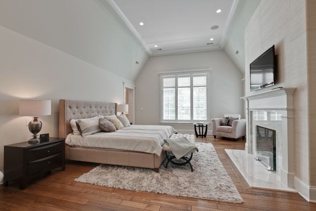 a spacious bedroom with a large bed and a fireplace