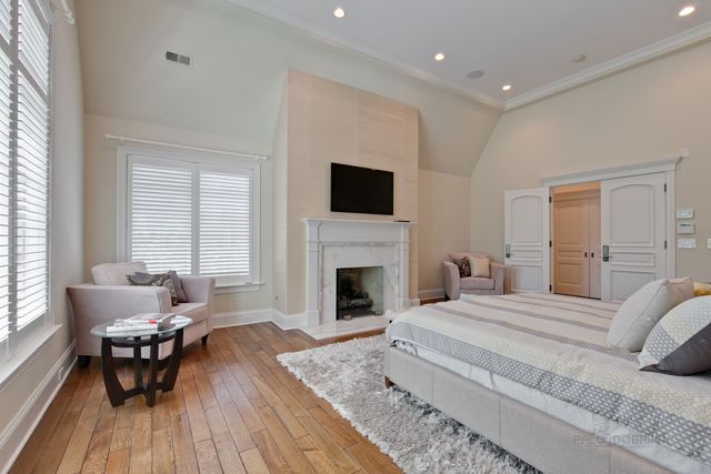 a spacious bedroom with a bed and a fireplace