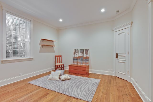 a room with wooden floor and furniture