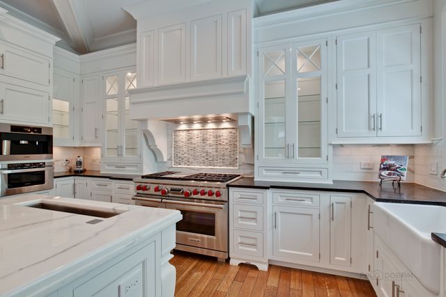 a kitchen with granite countertop a stove and a sink