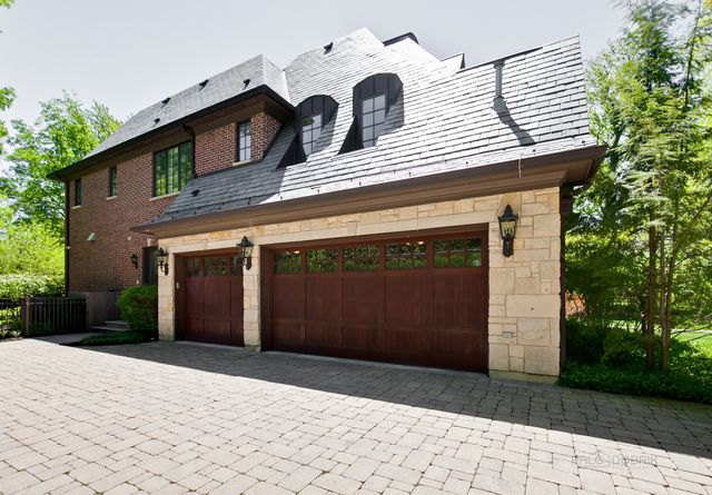 a view of a house with a yard and garage