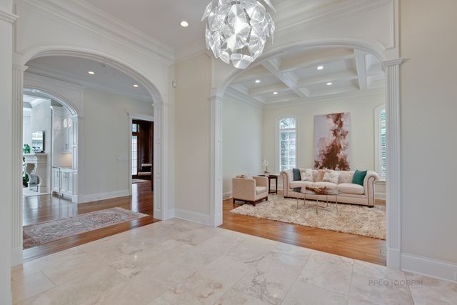 a living room with furniture and a chandelier