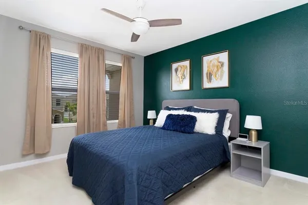 a bedroom with a bed and a large window