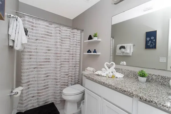 a bathroom with a sink vanity and toilet
