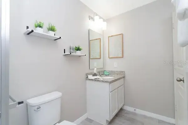 a bathroom with a granite countertop sink and a mirror
