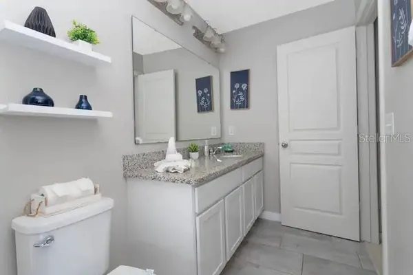 an aerial view of a house with a yard and large trees